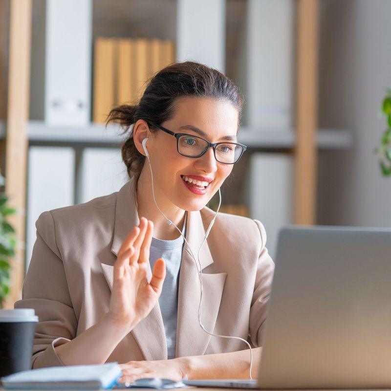 a woman sitting in front of a laptop computer